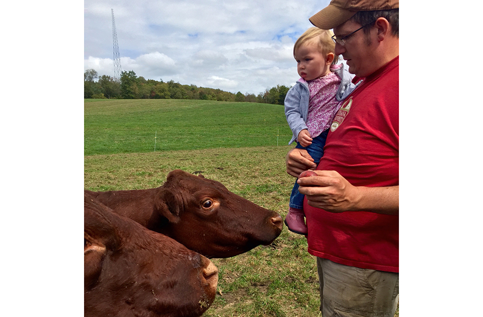 Charles with baby and cows
