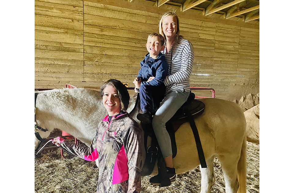 Jessie leading horse on family ride